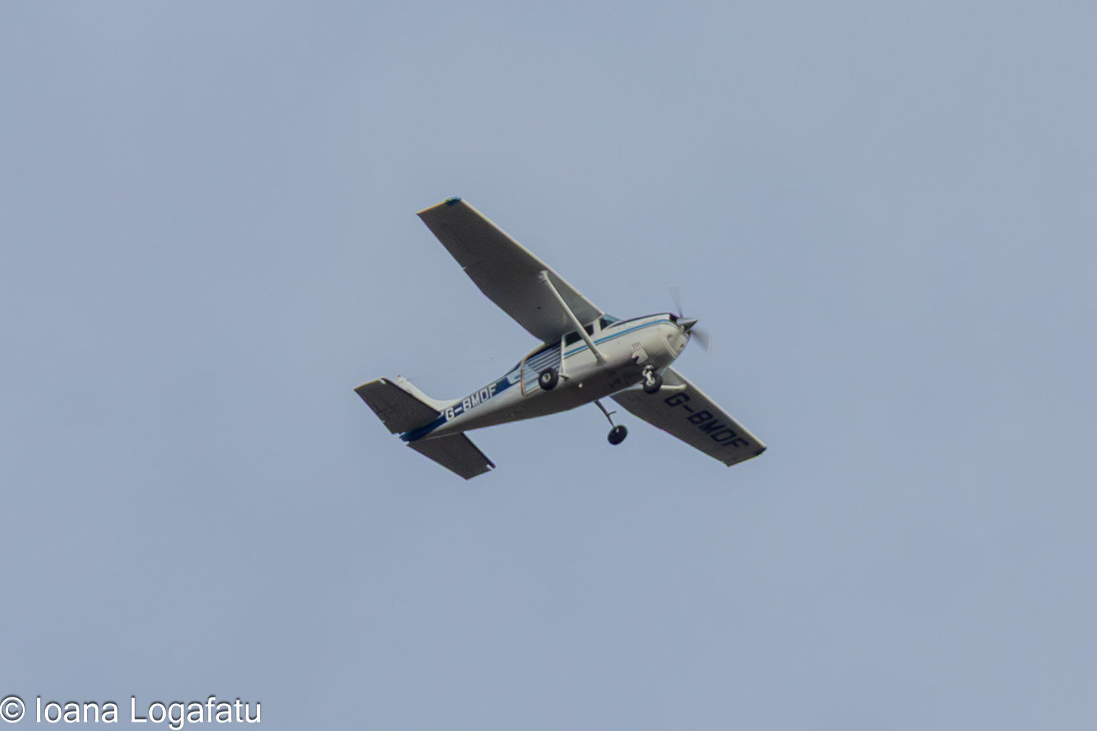 Classic aircraft soaring through a clear blue sky